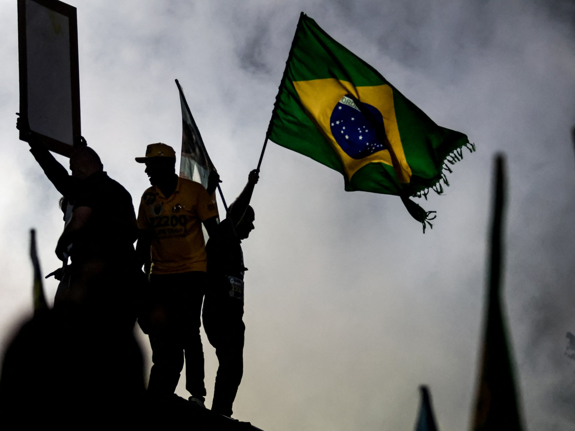 Voters waiting in line at a polling station during the tense 2026 Brazil election between Lula and Flavio Bolsonaro.