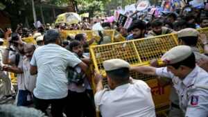 Delhi Police investigators reviewing digital evidence and AI-generated files on a laptop screen.