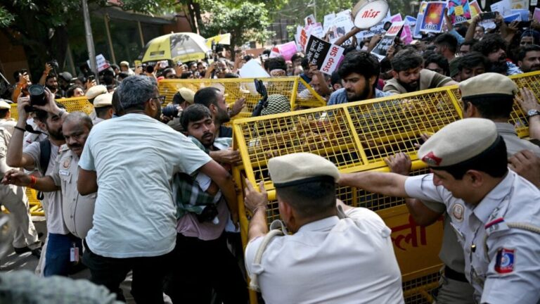 Delhi Police investigators reviewing digital evidence and AI-generated files on a laptop screen.