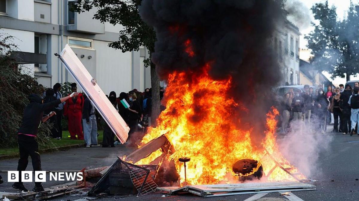 Riot police facing off against student protesters in France during school funding demonstrations.