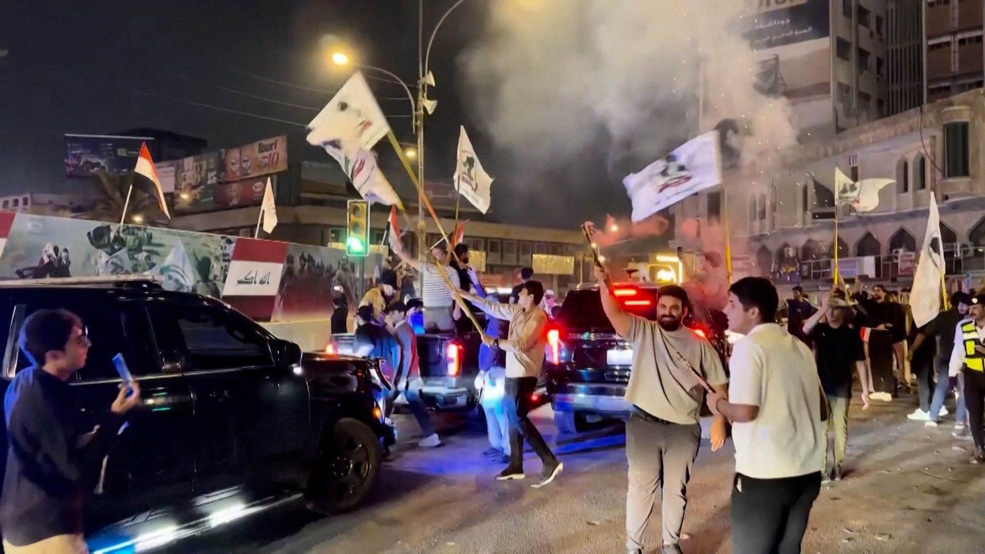 Iraqis celebrating the official withdrawal of US and international troops in a massive national gathering.