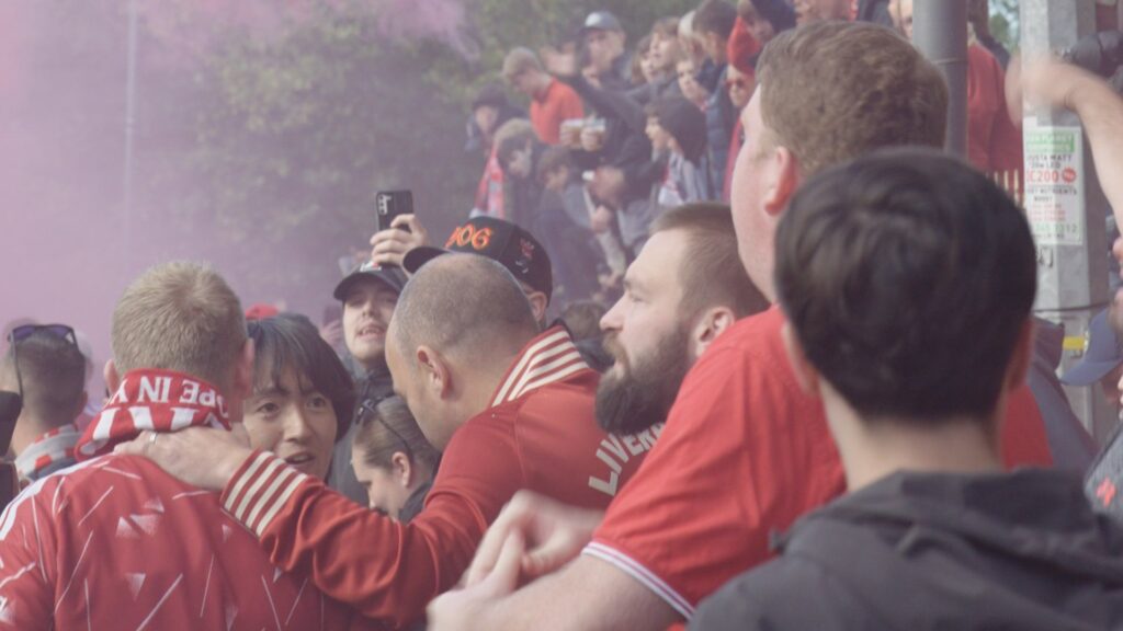 Value: Football fans reacting to the Man City financial breach verdict outside Anfield.