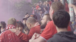 Value: Football fans reacting to the Man City financial breach verdict outside Anfield.