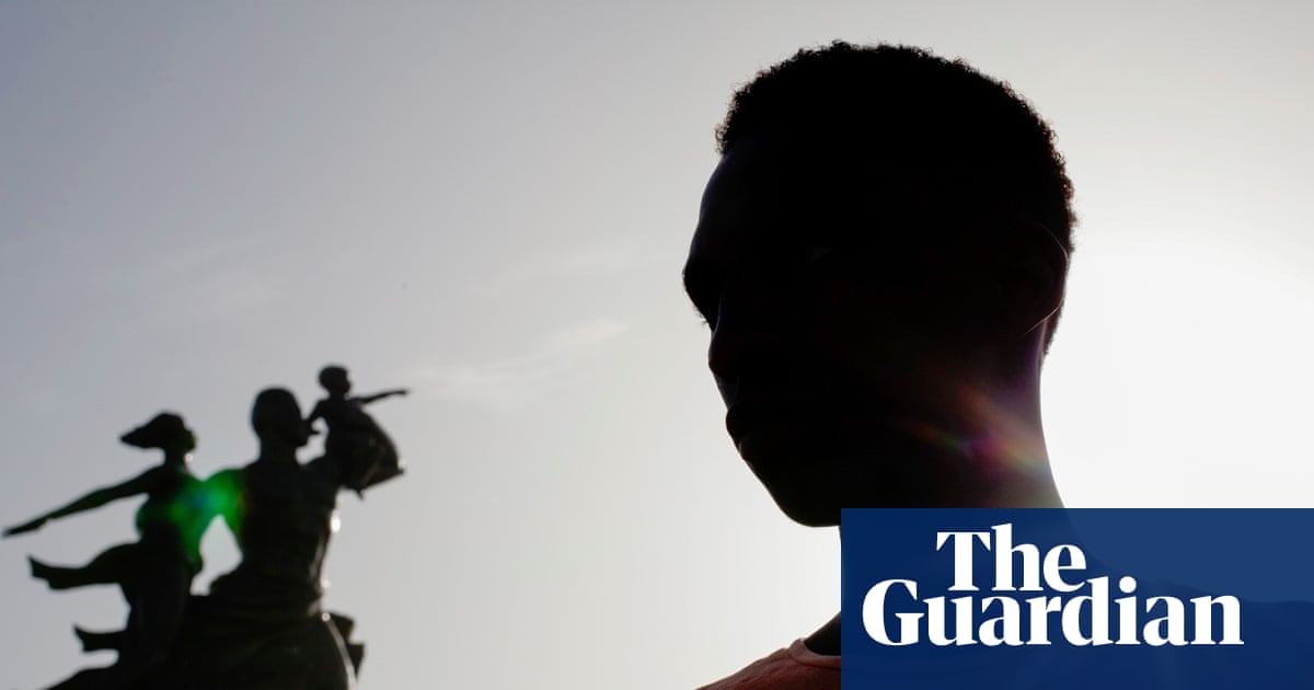 Value: A silhouetted figure looks at the African Renaissance Monument in Dakar amid rising state pressure on human rights.