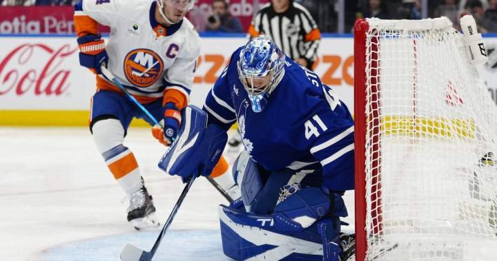 The Toronto Maple Leafs celebrating a 2-1 victory over the New York Islanders at home.
