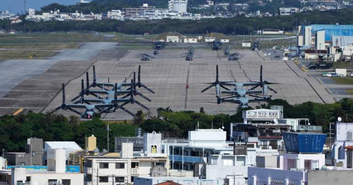 A photograph showing U.S. MV-22 Osprey transport aircraft parked at the U.S. Marine Corps Air Station Futenma in Okinawa, Japan.
